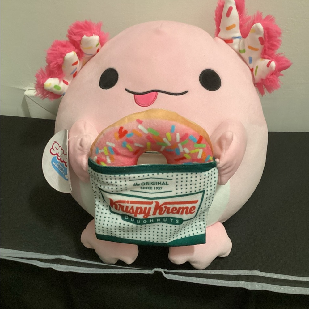 Snackle Pink Axolotl Plush Holding Krispy Kreme Donut